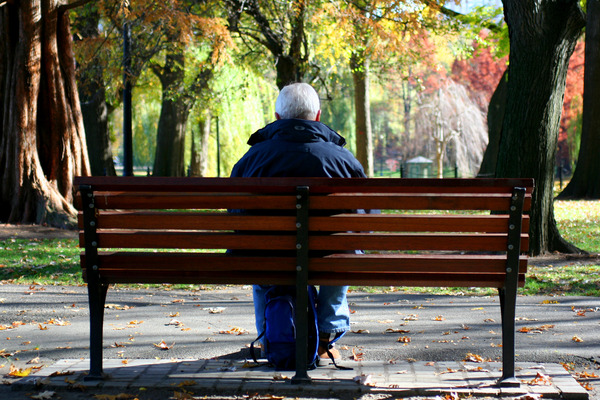 A man seated on park bench